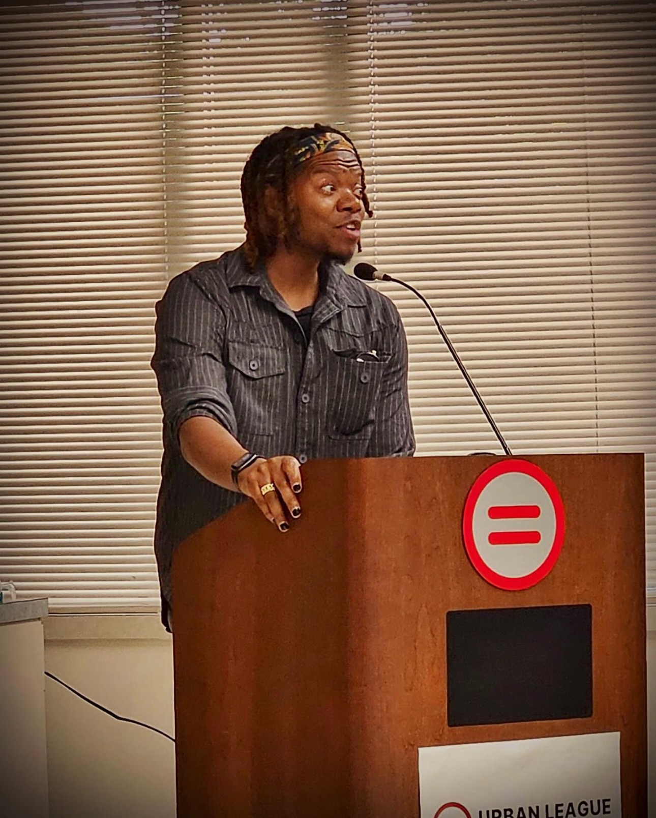 Adam L. McMath speaking at a podium